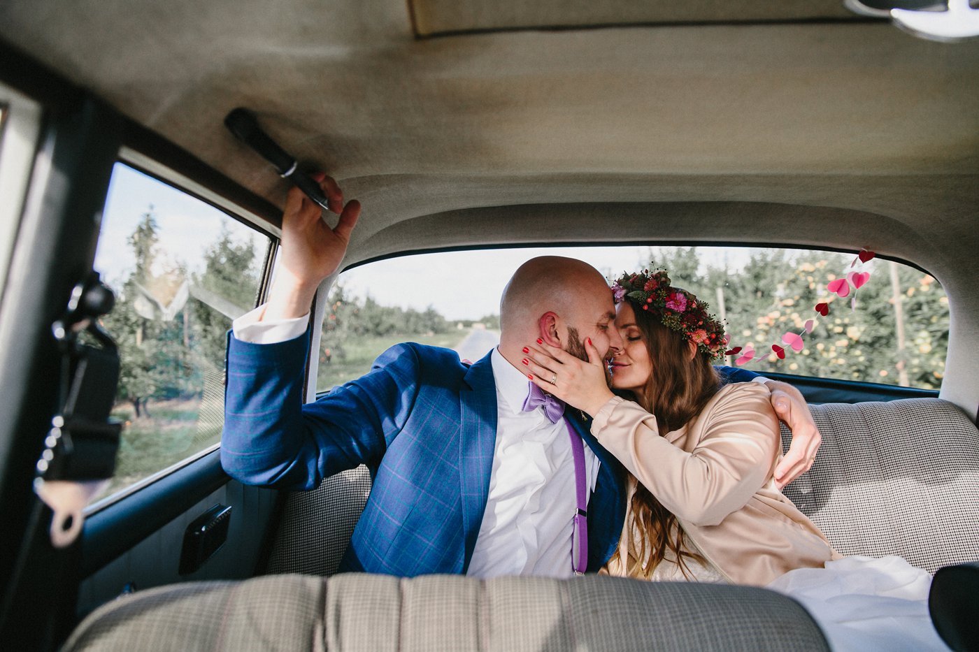 Urbane Hochzeit: Brautpaar küsst sich im Hochzeitsauto